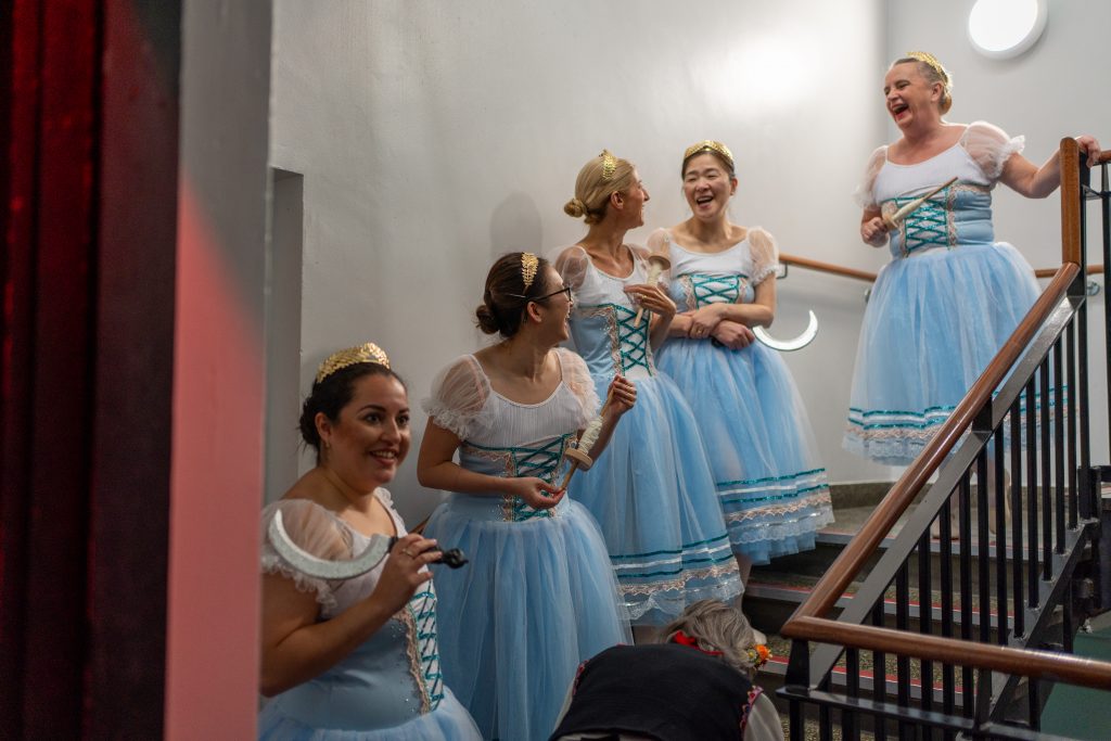 Dancers laughing backstage waiting to go on